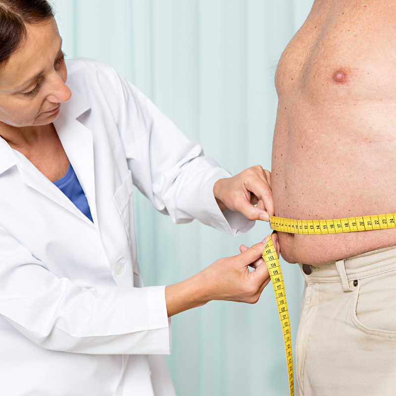 oncologist measuring obese patient